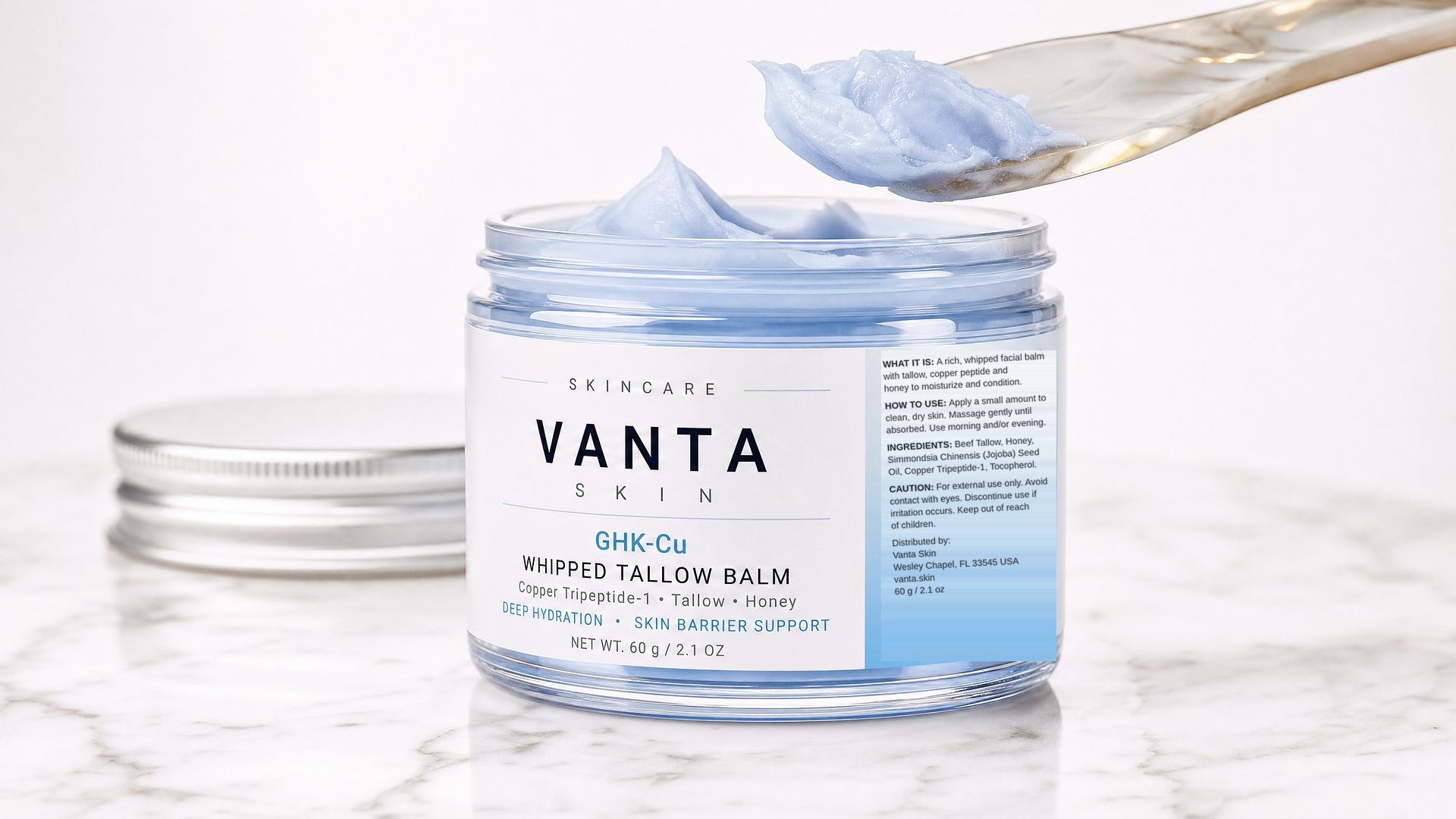 Open jar of Vanta Skin GHK-Cu Whipped Tallow Balm with spatula
